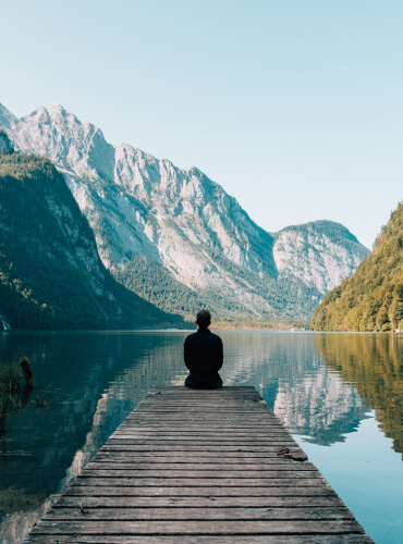 A person sitting down with a view of mountain