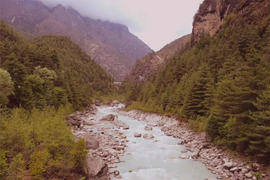a river on the way to namche between two hills